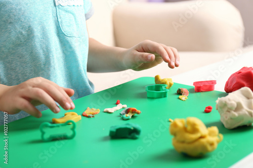 Child sculpts from plasticine, closeup