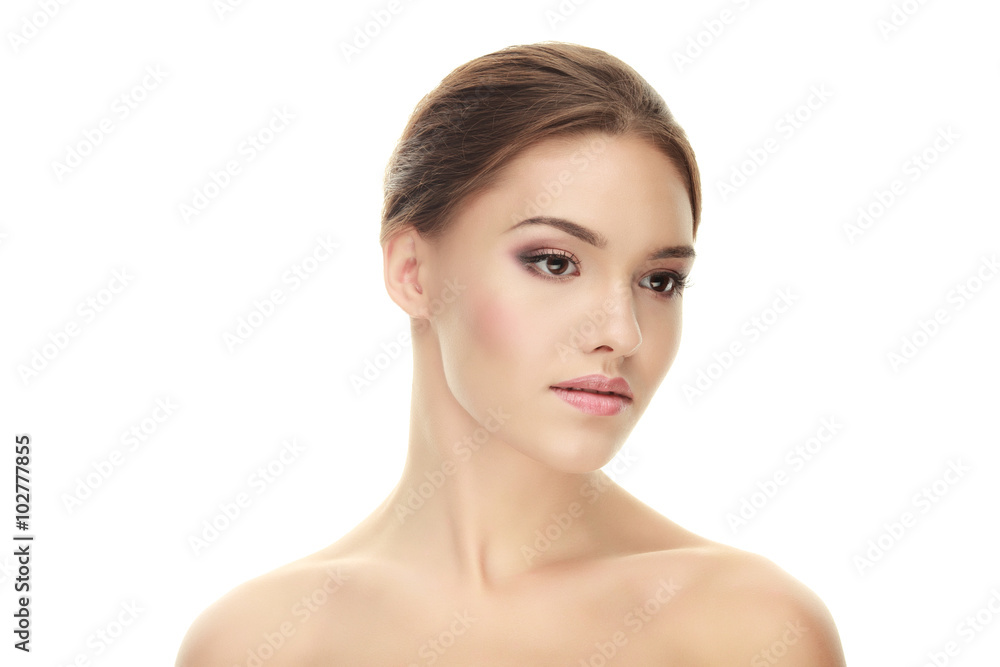 Closeup portrait of young calm brunette woman with trendy makeup posing with bare shoulders on white studio background Closeup portrait of young calm brunette woman with trendy makeup posing with bare shoulders on white studio background