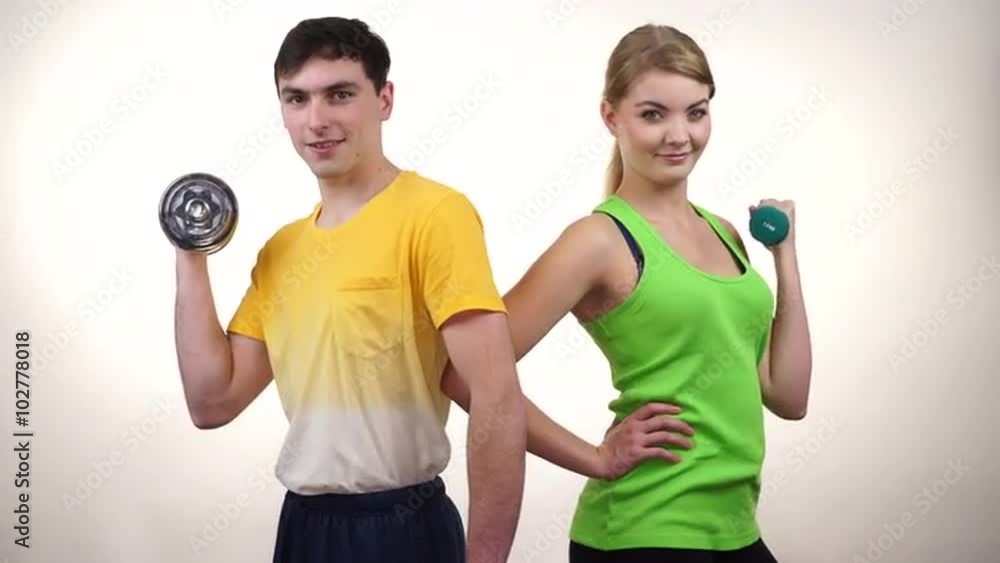 Couple exercising with dumbbells lifting weights 4K Couple exercising with dumbbells lifting weights 4K