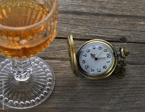 Vintage still life with ancient silver pocket watch on wooden ba photo