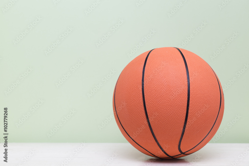Basketball on white table with green background Basketball on white table with green background