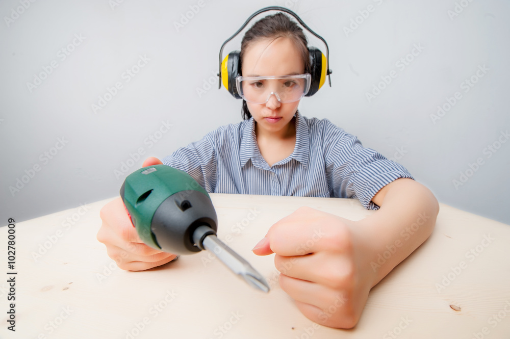 Young woman with a drill Young woman with a drill