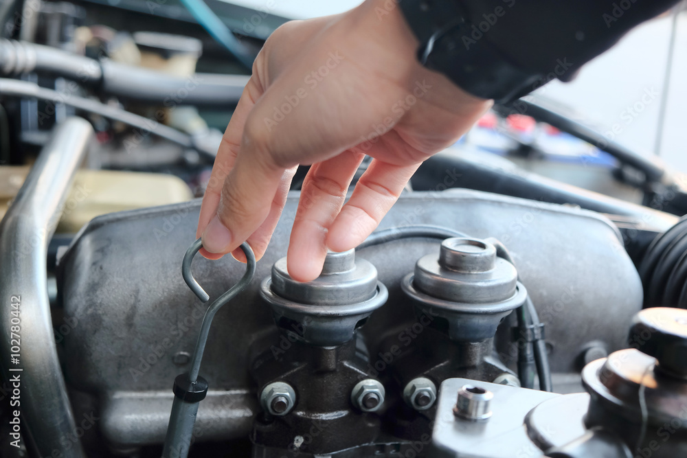 Image of a car mechanic checking the oil level. auto repair background