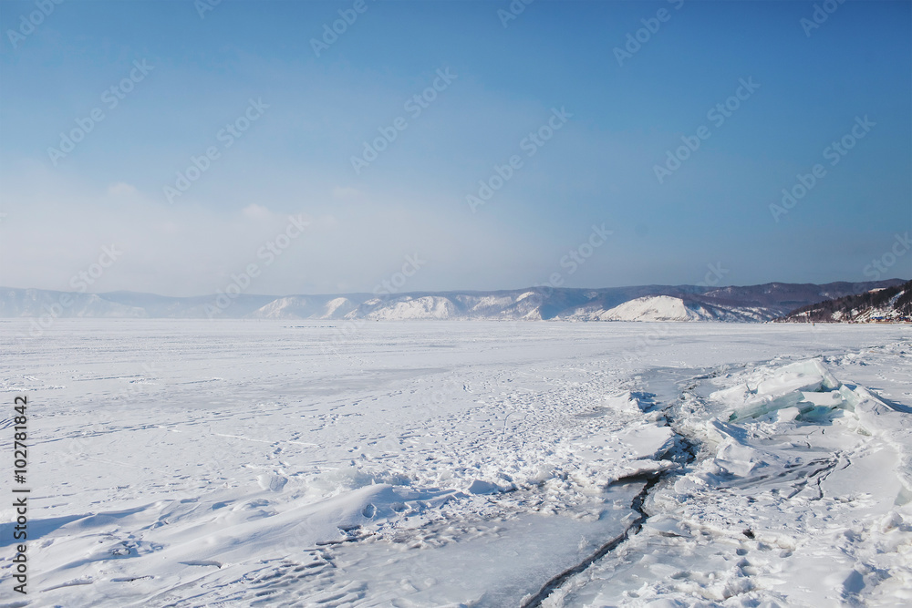
view over the frozen snow-covered mountains and Lake Baikal