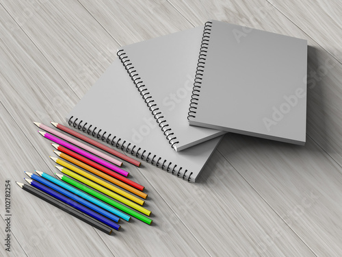 color pencil on checked notebook on wood background