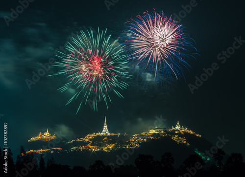 Fireworks show at night with pagoda foreground
