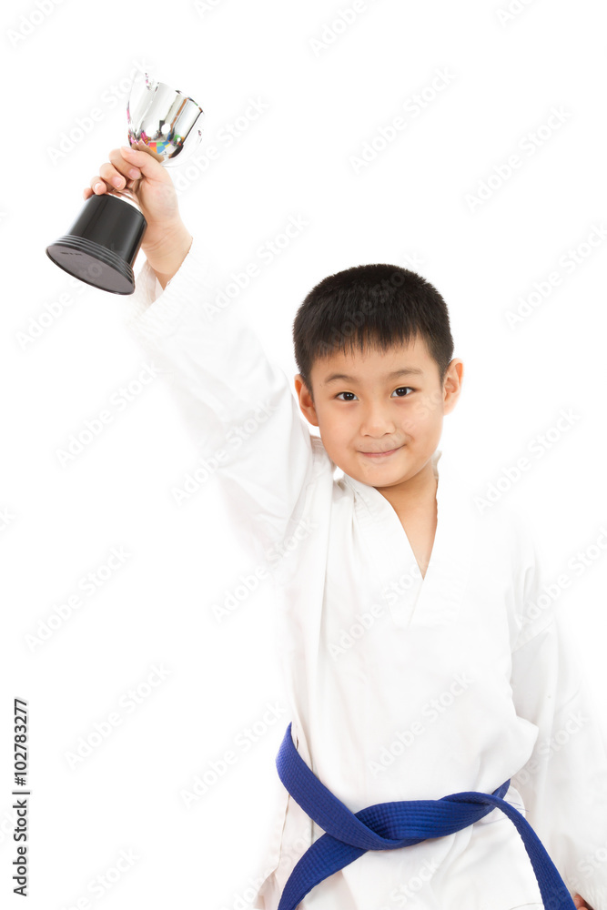 Asian Little Karate Boy Holding Cup in White Kimono Asian Little Karate Boy Holding Cup in White Kimono