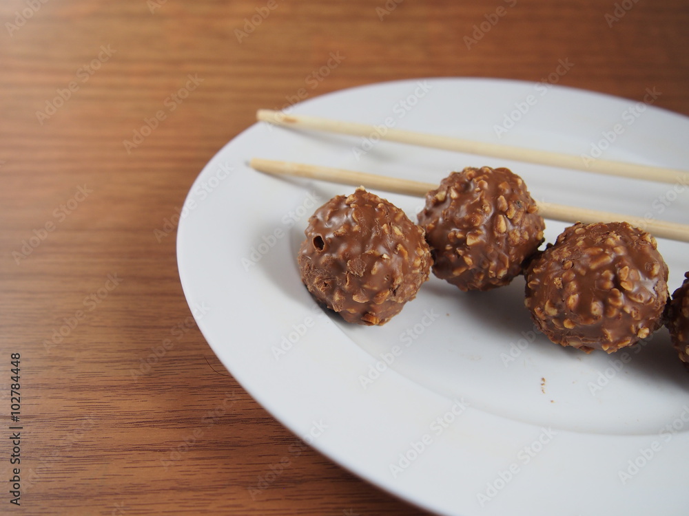 Milk chocolate balls with crisp hazelnut, snack, high calorie, fat, souvenir in Valentines Day Milk chocolate balls with crisp hazelnut, snack, high calorie, fat, souvenir in Valentines Day