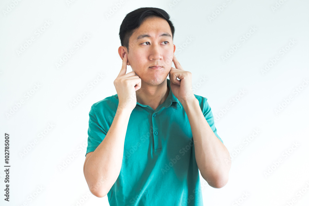 Stressed man covering his ears and do not want to hear, noise too loud Stressed man covering his ears and do not want to hear, noise too loud