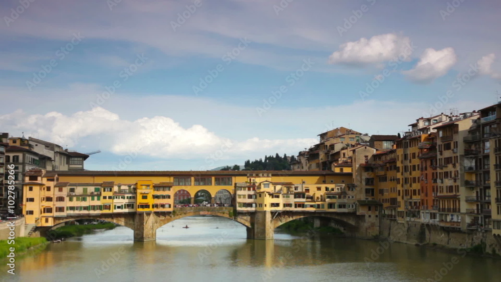 Panoramic view of Ponte Vecchio (Old Bridge) across Arno river and buildings on shores. Panoramic view of Ponte Vecchio (Old Bridge) across Arno river and buildings on shores.