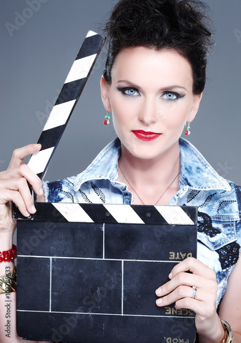 A female holding clapperboard.
