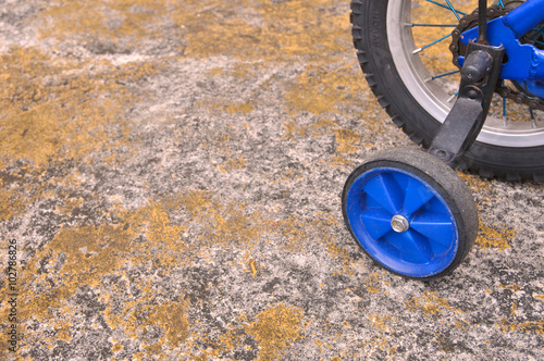 Training wheels on a blue children's bicycle