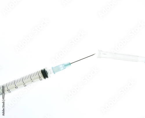 Syringe and needle being recapped, a common cause of needlestick injuries