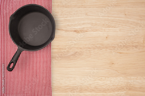 Empty pan on wooden deck table with tablecloth. Flat mock up for