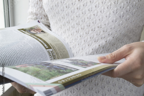 Woman leafing through magazine
