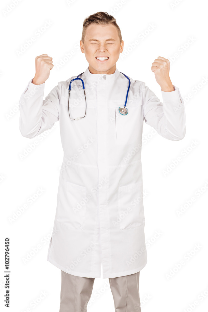 Young male doctor in white coat and stethoscope showing fist. P Young male doctor in white coat and stethoscope showing fist. P