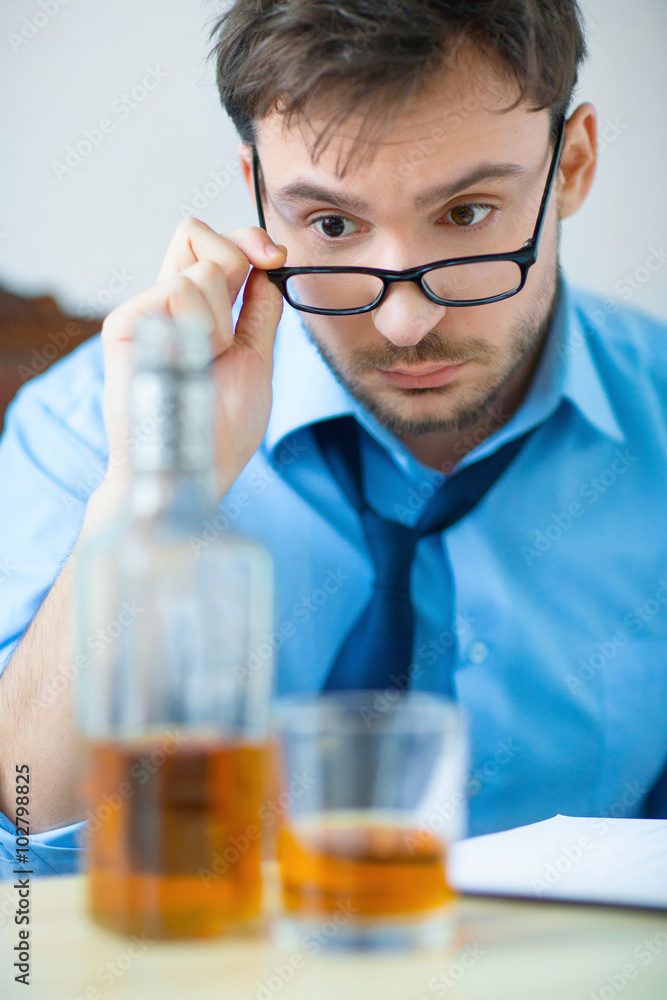 Drunk man drinking alcohol while working Drunk man drinking alcohol while working
