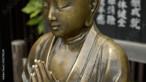 Iron Buddha statue in Asakusa zooming out, Japan. 