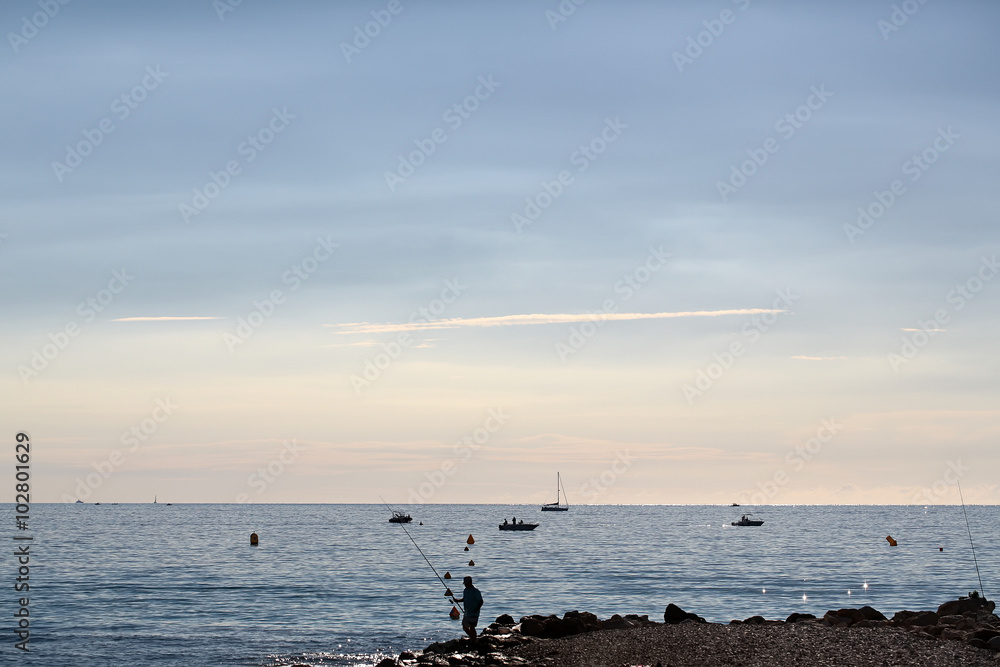 Fisherman on seascape background