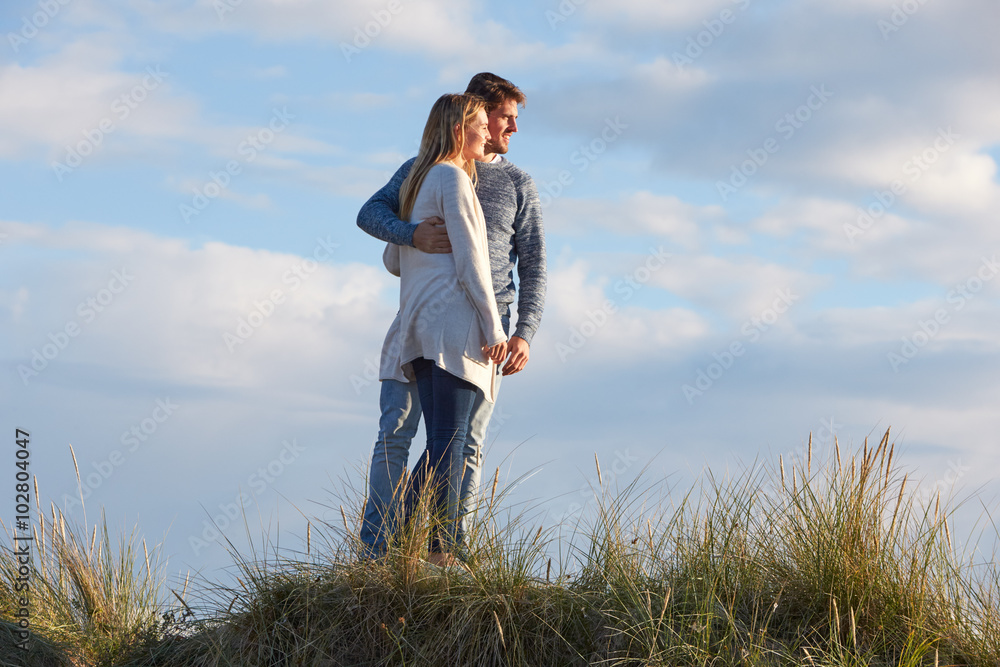 Couple Walking Through Sand Dunes Together Couple Walking Through Sand Dunes Together