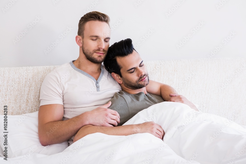 Asleep gay couple lying in bed Asleep gay couple lying in bed