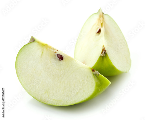 Slices of green apple on white background