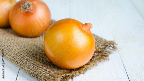 onions on hemp sack place on wooden
