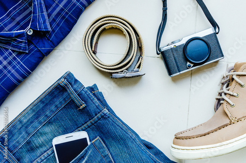 set of clothes and accessories for men on a ceramic background