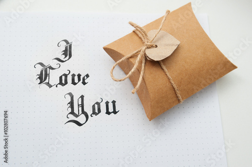 Text god bless you on paper texture and gift box with heart