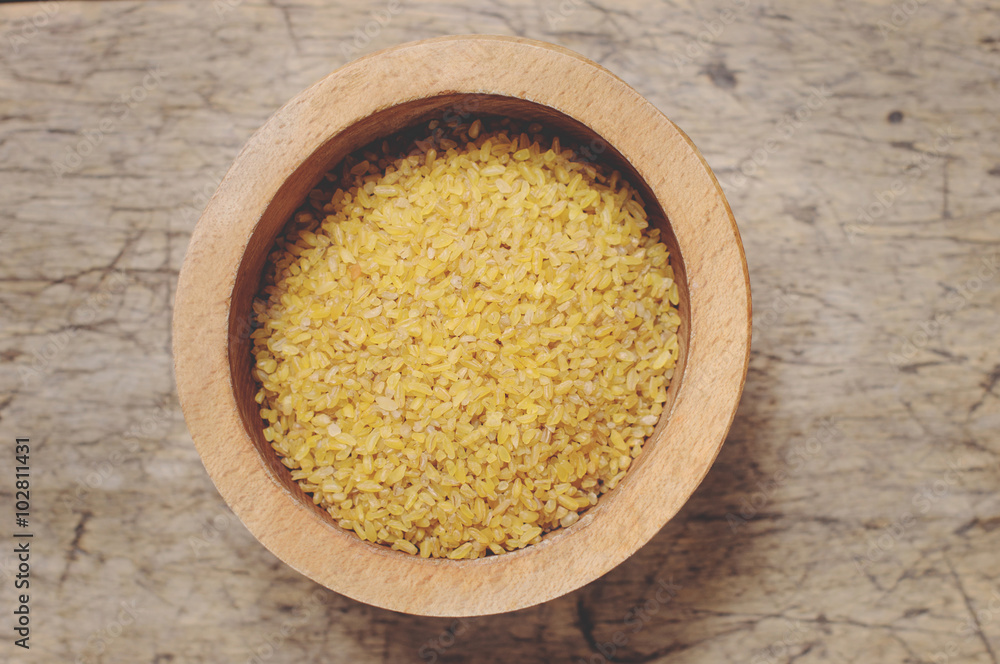 Raw Bulgur on wooden background Raw Bulgur on wooden background