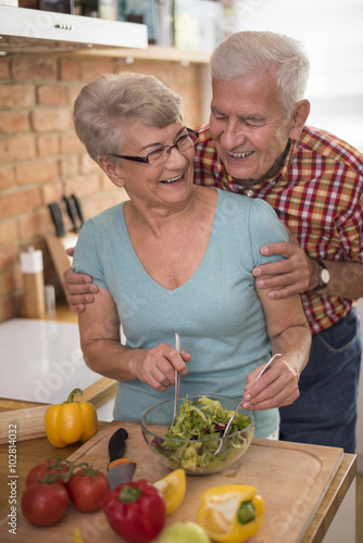 Senior couple preparing fresh salad together