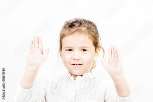 Portrait of little girl with hands up