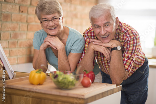 Portrait of happy seniors at the domestic kitchen