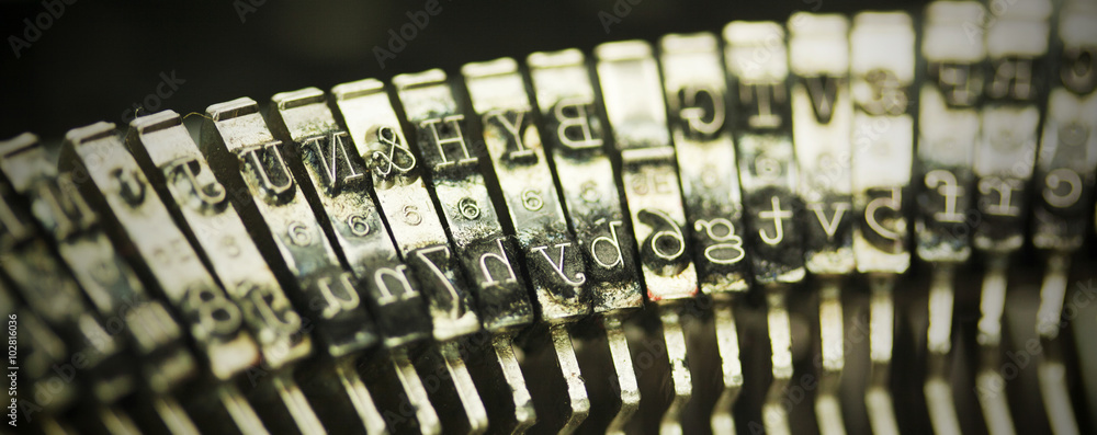 Hammer keys on an old type writer. Vintage filter.