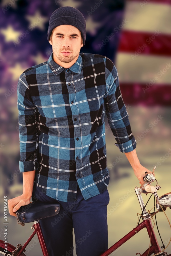 Composite image of portrait of hipster standing with bicycle Composite image of portrait of hipster standing with bicycle
