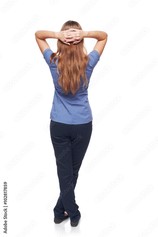 Back view of a woman standing with hands over head Back view of a woman standing with hands over head
