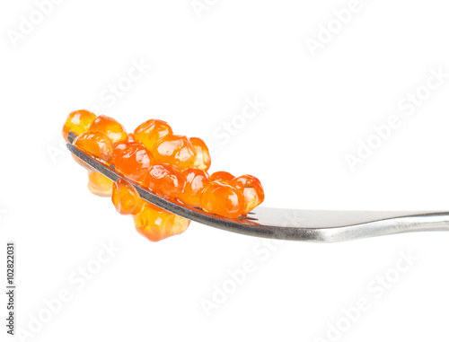 Red caviar on fork isolated on white