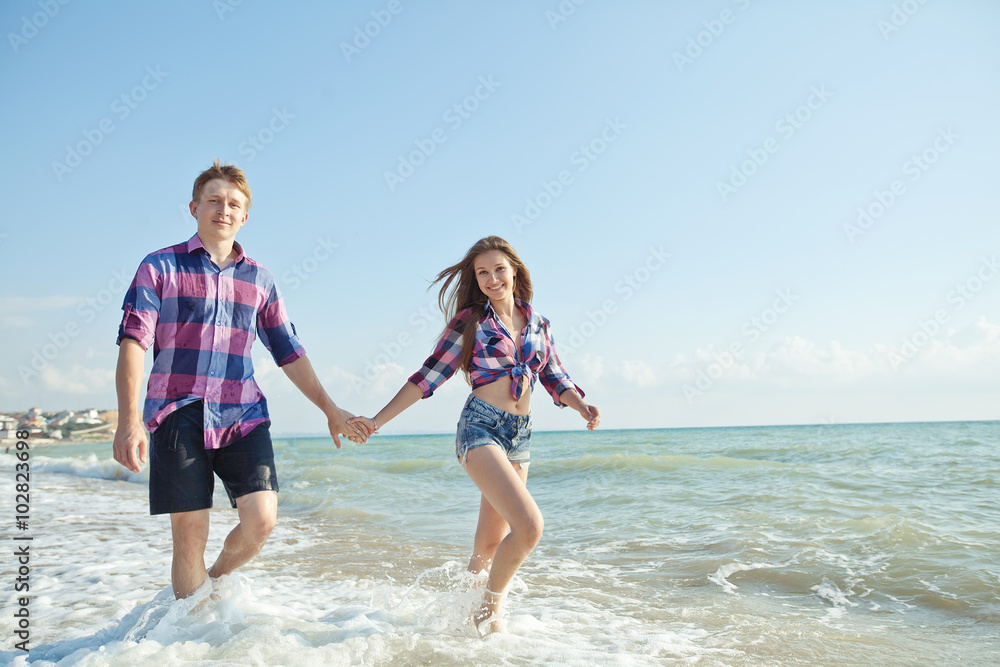 Happy pair walking on the beach Happy pair walking on the beach