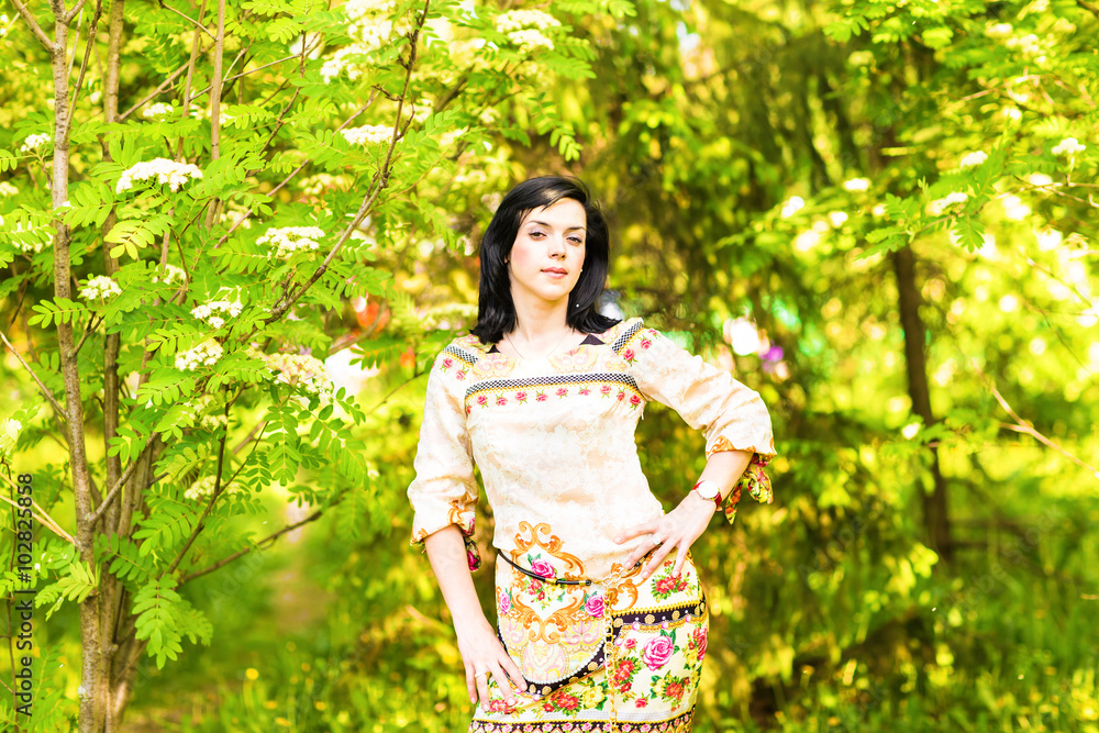Beautiful woman standing in a park in spring or summer Beautiful woman standing in a park in spring or summer