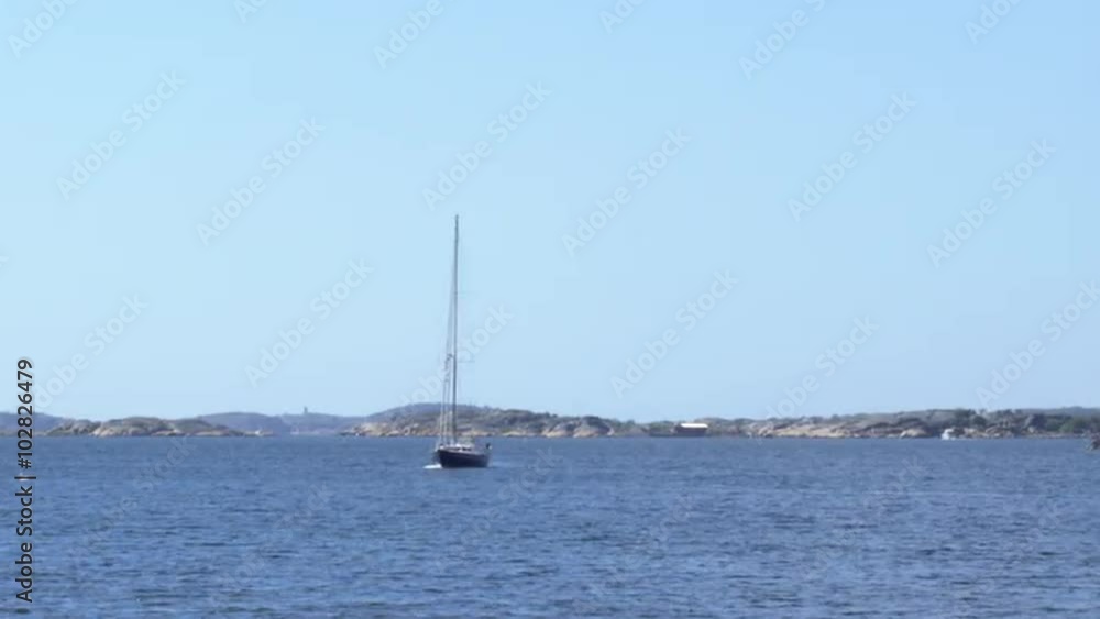 A sailboat is on the ocean by rocky islands a beautiful day at the end of May in the Gothenburg archipelago, Sweden.
A sailboat is on the ocean by rocky islands a beautiful day at the end of May in the Gothenburg archipelago, Sweden.