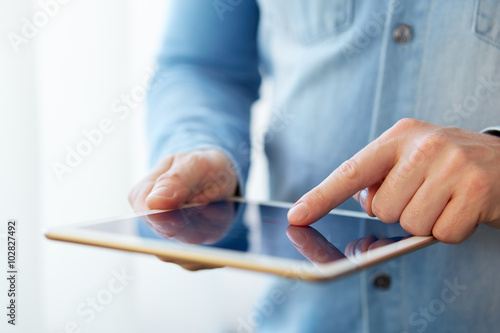 Man touching digital tablet