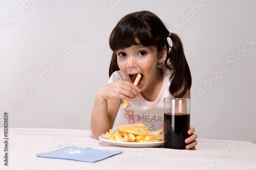 Little girl eating french fries