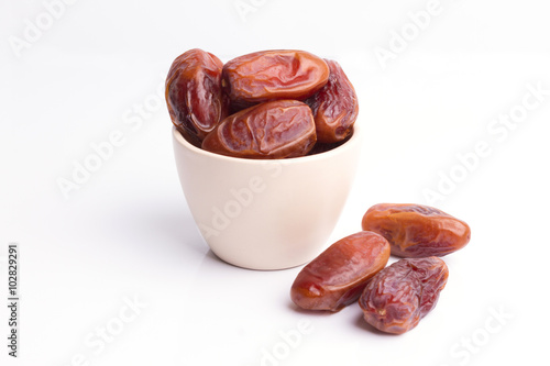 Dried dates fruit on white background