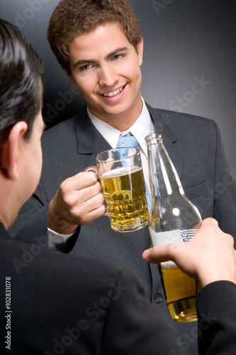 Business men pouring a glass of beer