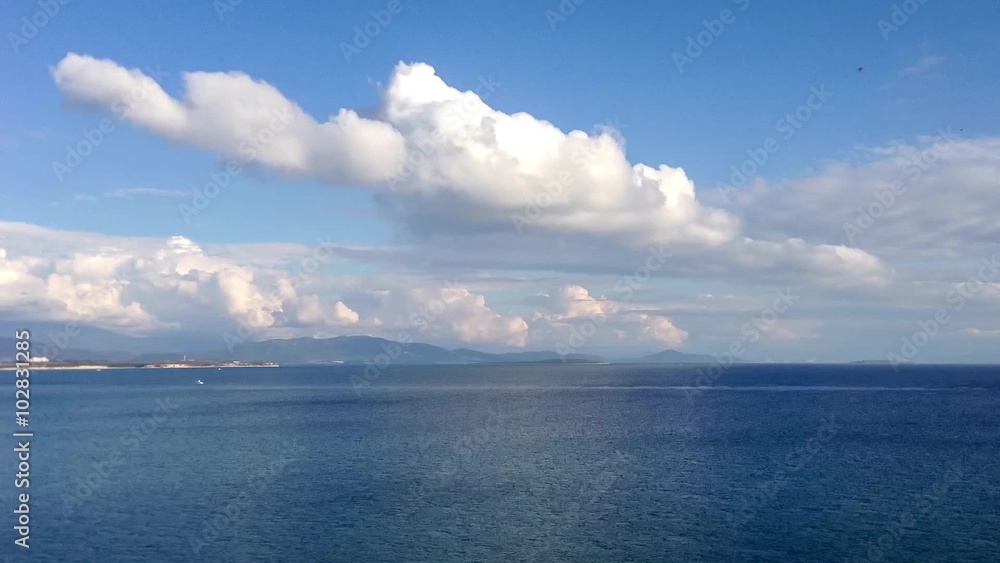 Timelapse of white cumulus clouds over the sea with boat in a sunny day. 4k Timelapse of white cumulus clouds over the sea with boat in a sunny day. 4k