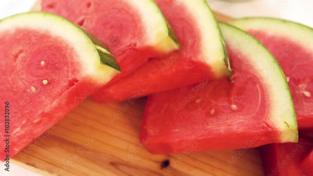 View of slices of watermelon on a wooden board View of slices of watermelon on a wooden board