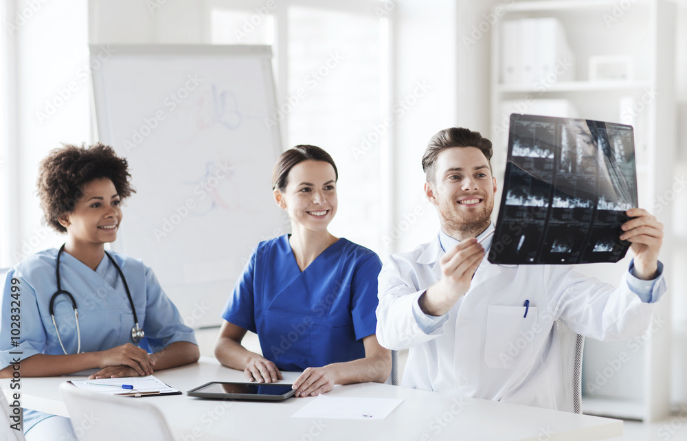 group of happy doctors discussing x-ray image group of happy doctors discussing x-ray image