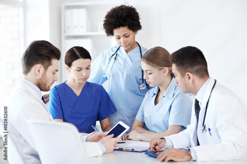 group of doctors with tablet pc at hospital