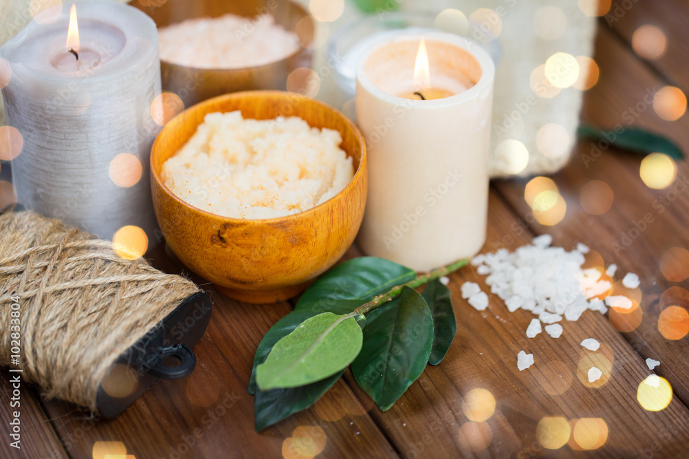 close up of natural body scrub and candles on wood close up of natural body scrub and candles on wood