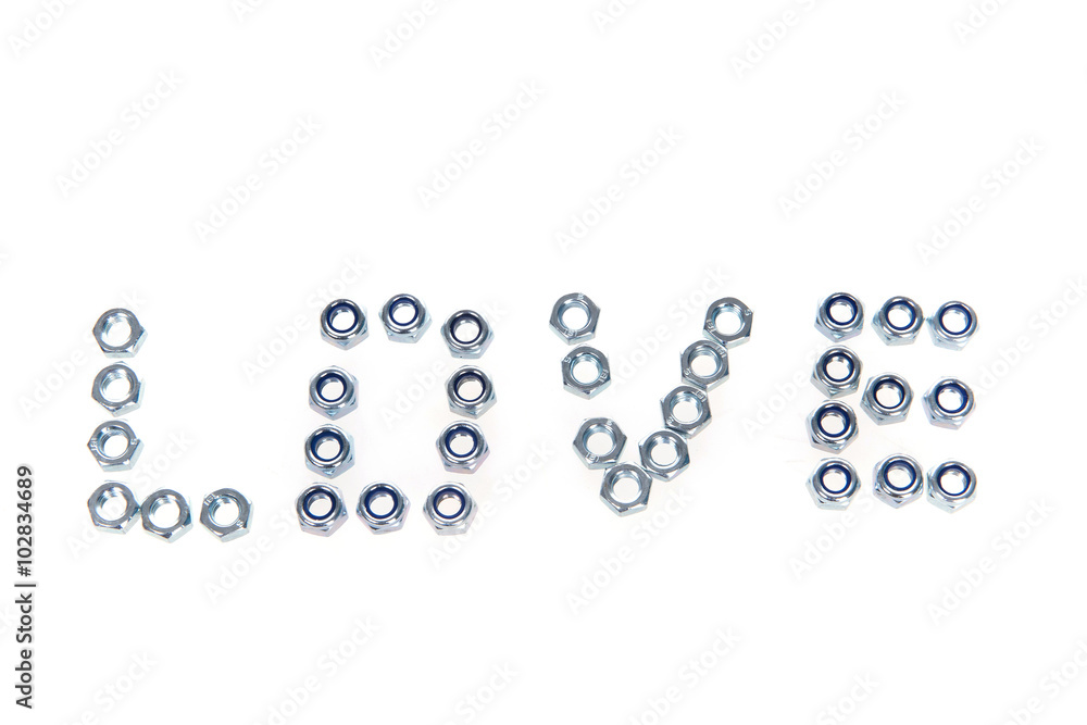 Metal nuts on white background laid out in the shape of heart Metal nuts on white background laid out in the shape of heart